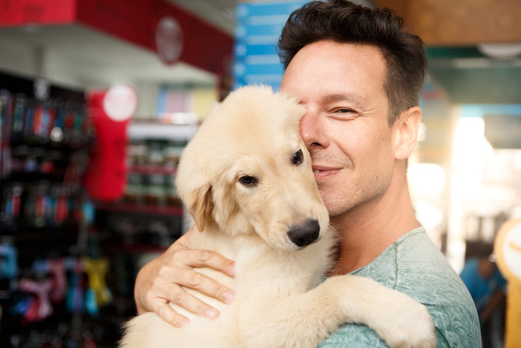 Man with his dog at pet shop